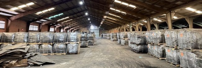 Warehouse storing palletized bulk bags and packaged materials for industrial storage and distribution.