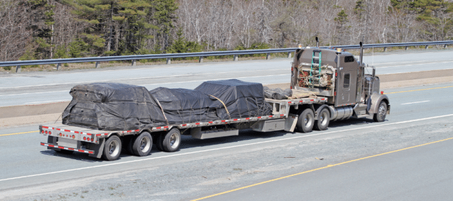 Flatbed trailer carrying evenly positioned packaged loads for balanced weight distribution